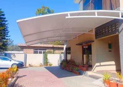 Wall-mounted tensile shade structure
